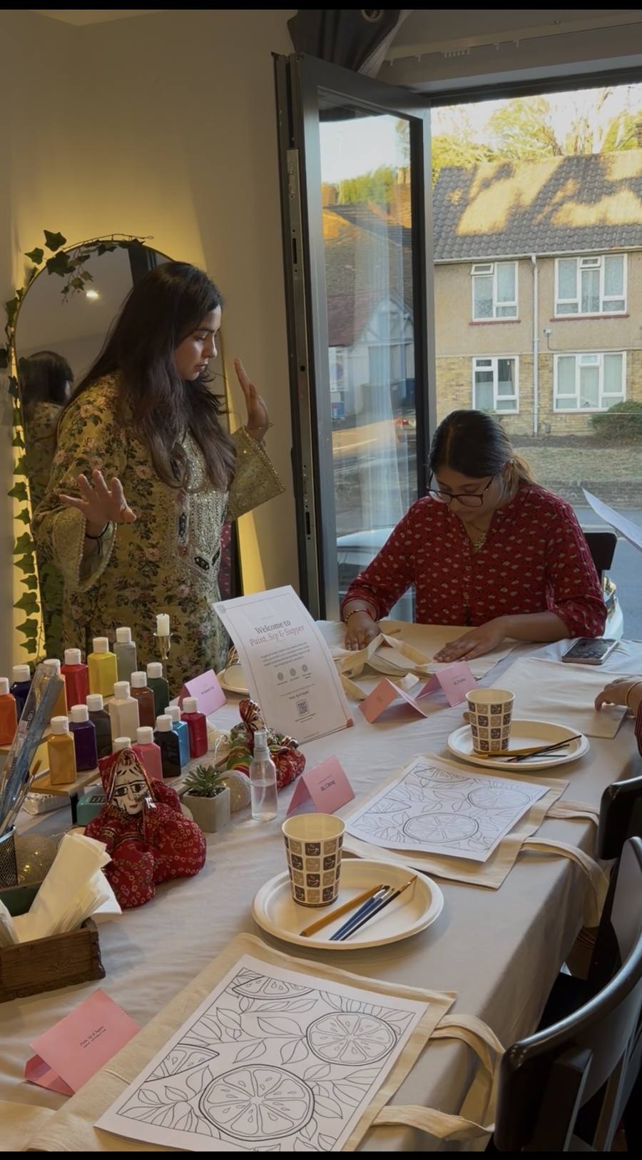 The host talking guests through painting technique and approach before the first brushstroke